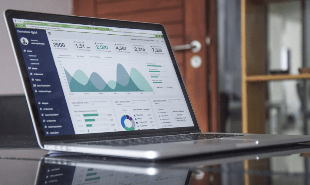 A computer screen in an office setting shows a digital marketing dashboard for conversion tracking &mdash; an important facet for understanding why attribution is breaking in 2026. 